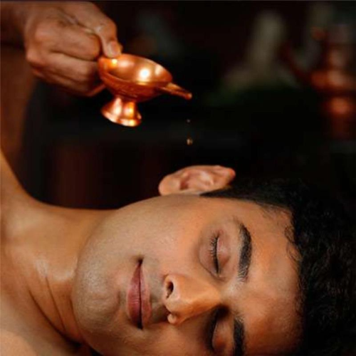Ayurvedic Karna Poorana treatment with medicated oil application 